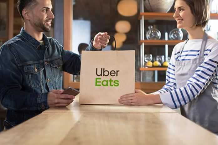 65EN-EEUU. Uber amplía sus negocios, también repartirá comidas compra Postmates